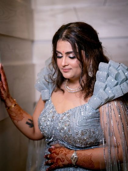 A portrait of the bride-to-be, her unique ruffled sleeves and sparkling dress making a fashion statement.