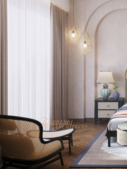 A cozy reading corner featuring a classic rattan armchair and ottoman, perfectly complementing the room's organic and sophisticated aesthetic.