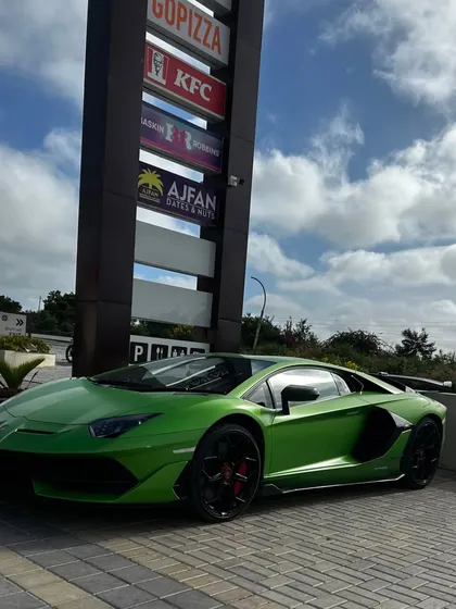 The magnificent green Lamborghini Aventador parked next to our brand pylon, which lists the variety of food outlets available.