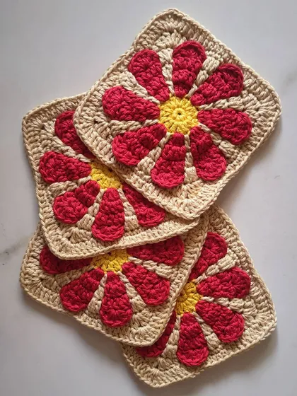 These are the individual daisy granny squares that are the building blocks for the crossbody bag. Learning to make a granny square is a classic crochet skill that opens up a world of possibilities.