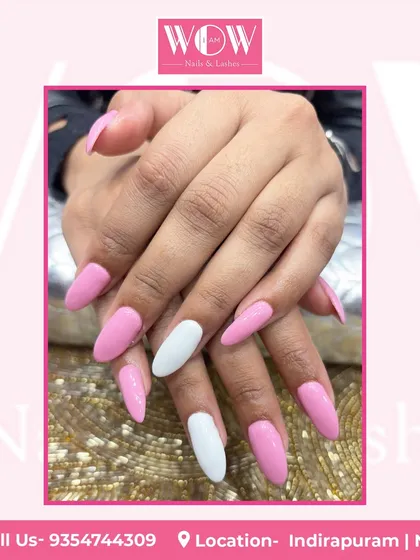 A playful and chic design combining solid pink and white nails on long, almond-shaped extensions. It's a simple yet bold color-blocking statement.