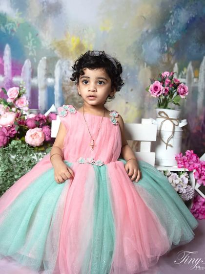 A slightly different pose from the garden party theme, showing the toddler's thoughtful expression.