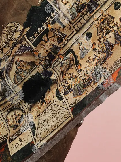 A close-up of the detailed courtly scene depicted on the saree.