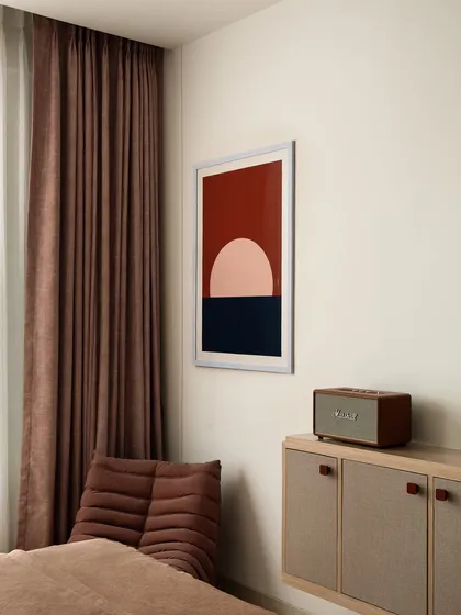 A detail shot of the custom console, with its fabric-paneled doors and unique red leather pulls. The abstract artwork above was also selected by us to complete the look.