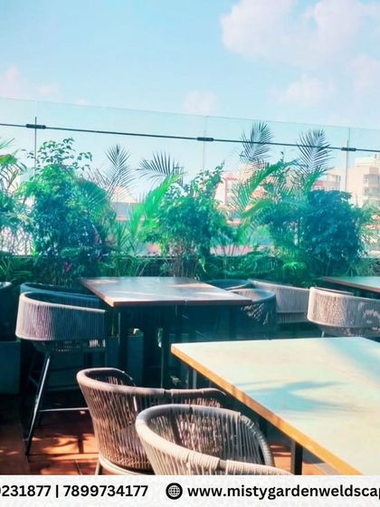 The rooftop seating area at Skydeck, where we used tall, leafy plants to create a sense of privacy and a tropical oasis feel, separating the dining space from the city view.