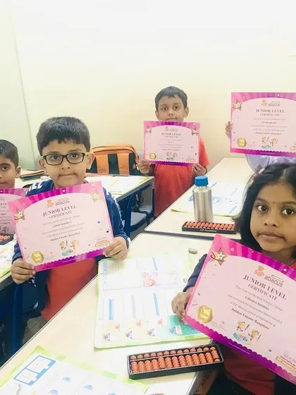These young learners are proudly holding their Junior Level completion certificates. It's the first major milestone in their abacus journey, and they have all done so well.