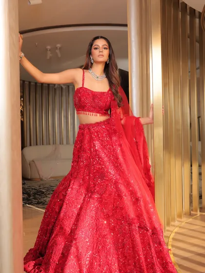 A powerful look for the Alaya Collection campaign, featuring a stunning red lehenga. The makeup is bold yet elegant, with a defined eye and glowing skin to complement the grandeur of the bridal couture.