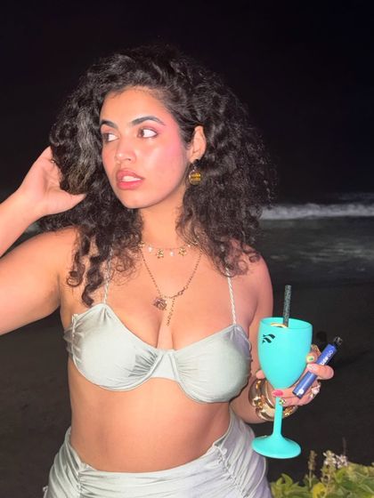 A close-up shot at the beach club, showing my makeup and accessories. It's all about the details that complete the 'big hair energy' look.