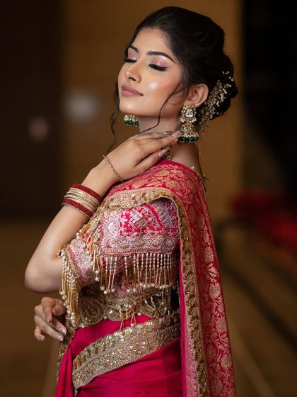 A moment of elegance. The soft lighting highlights her glowing skin and the beautiful details of her blouse, showing how the makeup enhances her overall radiance.