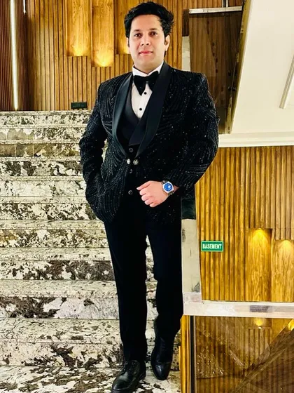 Our client looks absolutely stunning in this fully embellished black tuxedo. The intricate beadwork covers the entire jacket, creating a luxurious and celebratory look for a formal wedding event.