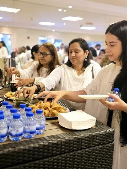 Participants at a hybrid event enjoy refreshments. Our programs are not just about lectures; they are about building a warm community where people can connect and share.