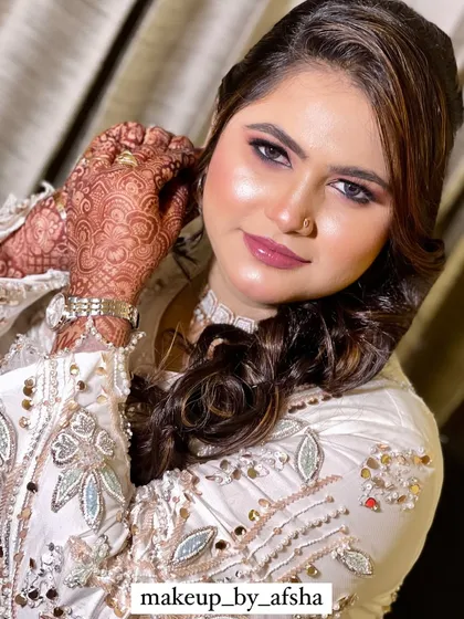 A happy, smiling portrait that shows off her beautiful makeup.
