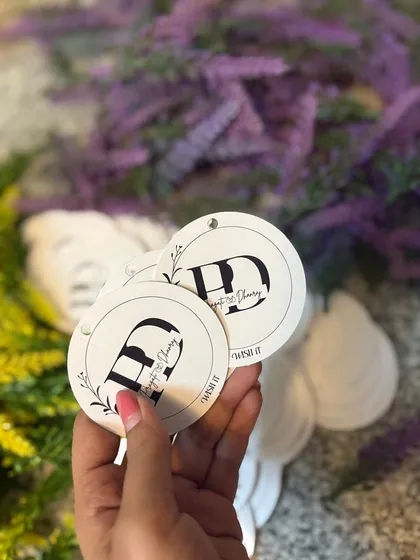 Personalized tags that tell your story. For a wedding, we created these beautiful tags with the couple's initials to add a bespoke touch to their return favors.