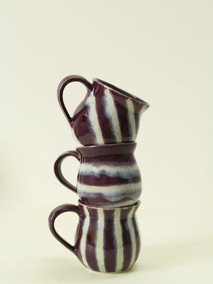 A playful stack of my Alluring Amethyst cups. The deep purple and white stripes are hand-painted, so each cup has its own unique rhythm and pattern.