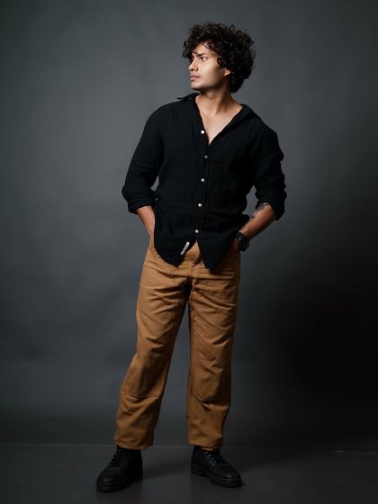 A classic relaxed pose with hands in pockets, showcasing a confident and approachable look for a male model's portfolio.