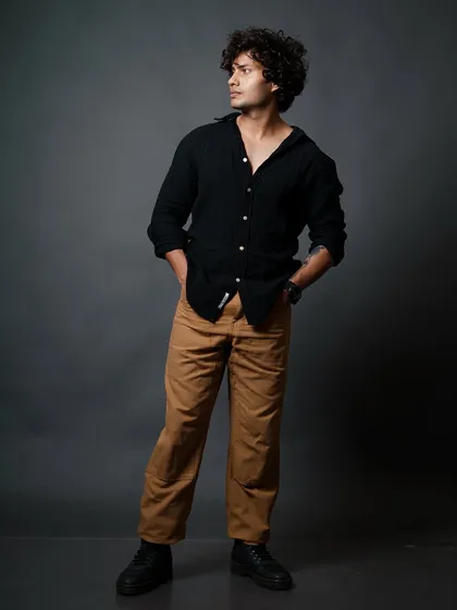 A classic relaxed pose with hands in pockets, showcasing a confident and approachable look for a male model's portfolio.
