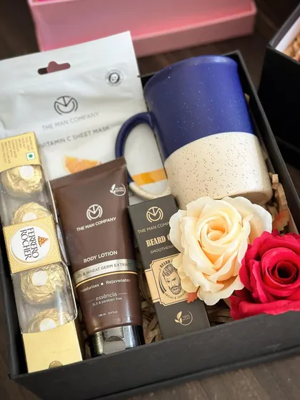 A classic 'Hamper for Him' featuring a full grooming kit from The Man Company, including beard oil and body lotion, plus a coffee mug and Ferrero Rocher.