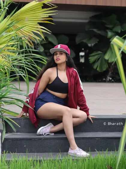 A cool, casual pose with a baseball cap, perfect for a sportswear or street style brand.