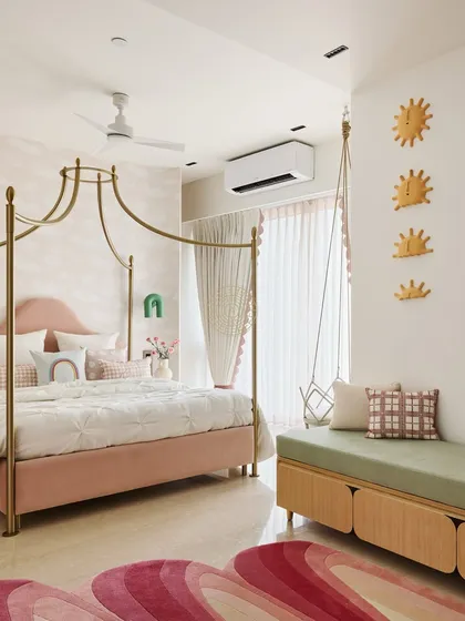 Designing rooms for children is one of my favorite things to do. For this little girl's bedroom, we created a whimsical and dreamy space with a pink canopy bed, cloud-print wallpaper, and a cozy green bench with a swing. It's a playful room designed to spark imagination.