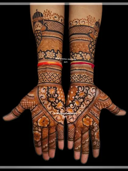 This design for a guest features a heart-shaped pattern on the palm, filled with traditional motifs and topped with palace architecture on the wrist.