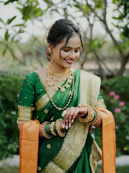 A bride admiring her intricate mehendi on her wedding day.