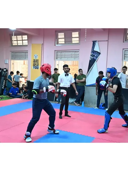 Two fighters face off at the start of a match, demonstrating focus and readiness. The mental aspect of competition is as important as the physical.