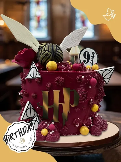 Accio, cake! This magical Harry Potter themed cake is ready for a wizarding celebration, complete with a golden snitch, the Deathly Hallows symbol, and the iconic HP logo in a rich burgundy buttercream.