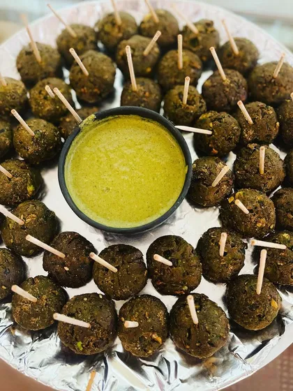 A platter of Hara Bhara Kebabs, a healthy and tasty vegetarian starter. Made with a mix of spinach and green peas, they are served with a fresh mint chutney.