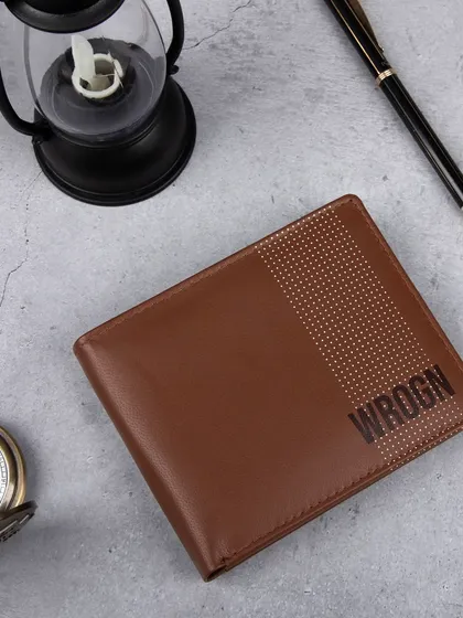 A styled flat-lay of the dotted 'WROGN' wallet.
