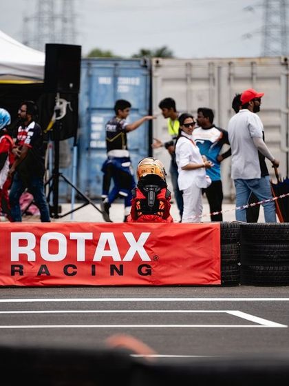 The pit lane at the Coastt track, with the Rotax Racing branding prominent.