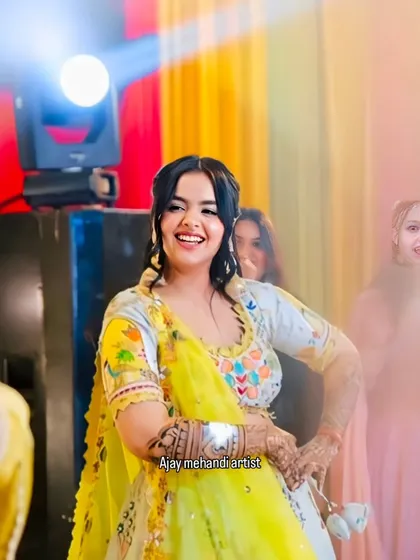 A joyful moment on the dance floor. The bride's intricate mehndi is a beautiful accessory to her festive look.