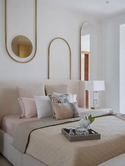This Chennai bedroom blends American contemporary style with a soft, serene palette. We used blush pinks, creamy whites, and whispers of gold to create a calm retreat. The bedside tables with sculptural marble lamps are a particular highlight.
