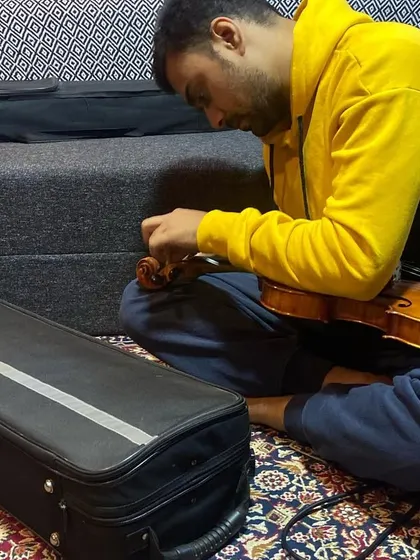 A musician tuning his violin during our recording session. The attention to detail and dedication of my collaborators is always inspiring.