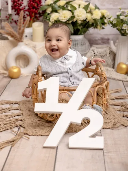 Celebrating six months of smiles! We create special setups to mark every milestone, like this half-birthday shoot, ensuring you never miss a chance to capture how quickly your little one is growing.