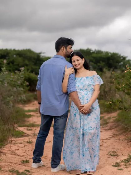A gentle moment during an outdoor maternity shoot. The natural landscape and soft light create a romantic and peaceful setting for this beautiful couple.
