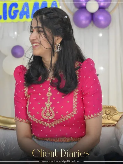 "Client Diaries" - a happy client in a custom pink and grey lehenga, her smile lighting up the room.