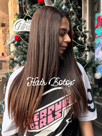 A side profile showcasing the sleek finish of a Hair Botox treatment. The hair falls smoothly without any of the frizz or flyaways that were present before the service.