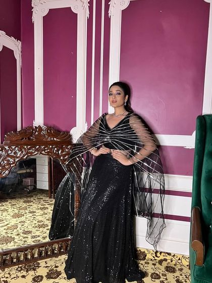 The unique sheer dupatta with silver stripes adds a futuristic and edgy touch to this black sequin lehenga. It’s a detail that sets this rental outfit apart.