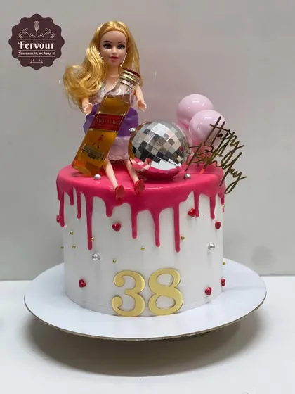 A fun twist on a Barbie cake for a 38th birthday. This design features a Barbie doll enjoying a miniature bottle of Johnnie Walker Red Label.