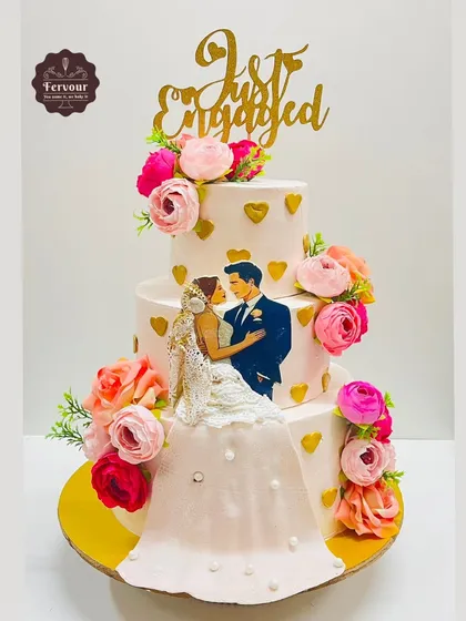 To celebrate a new beginning, I created this three-tier "Just Engaged" cake. It features a beautiful illustration of the couple, a flowing fondant dress detail, and is decorated with colourful flowers, making it a personal and romantic centerpiece.