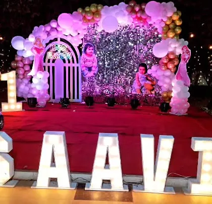 A glamorous first birthday party for Saavi. We used a beautiful pink sequin wall as the backdrop, framed by a pink and gold balloon arch, and personalized the space with large, light-up marquee letters spelling out her name.