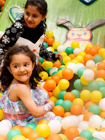 Two little mermaids having a blast in the ball pit. Our play zone provides endless fun and is a safe space for kids to enjoy.