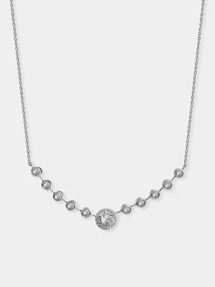 A silver necklace with a station design of bezel-set crystals. This image clearly shows the entire design of the necklace as it would sit on the neck.