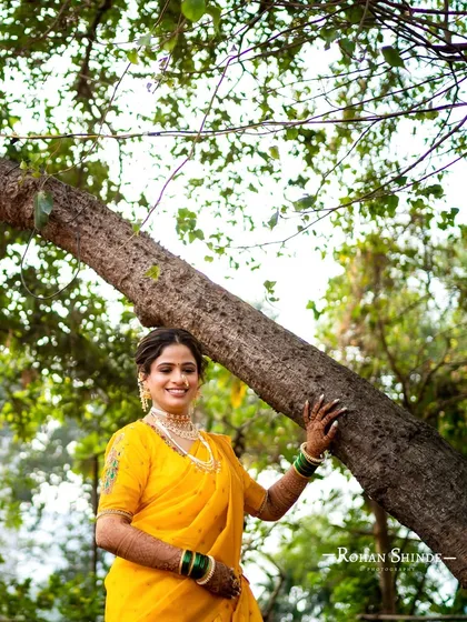 A professionally shot photo of the same yellow Navari look, capturing the beautiful details of the makeup and outfit in the natural outdoor setting.