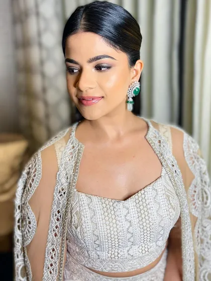 This angle highlights her radiant complexion and the clean, sophisticated feel of the overall look.