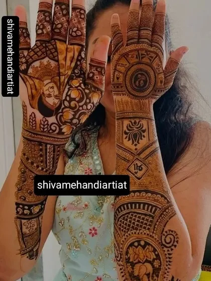 A unique design featuring a portrait of the bride on one hand, while the other is adorned with a large mandala and other traditional patterns.