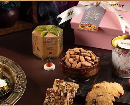 Another one of our festive indulgence boxes for Diwali, showcasing a mix of healthy snacks, nuts, cookies, and aromatic cones.