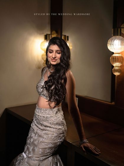 A portrait of the bride, her shimmering, fitted gown and soft waves perfectly capturing the 60s glam mood.