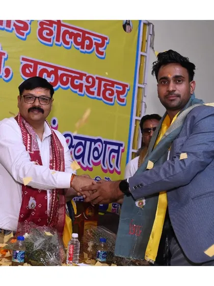 A handshake and a moment of recognition on stage in Bulandshahr.