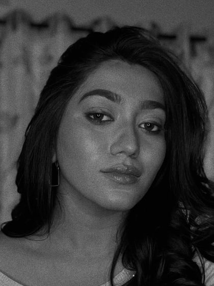 The same 'glass skin' look in black and white, emphasizing the highlights and contours of the face.